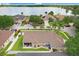Aerial view showcasing a lakefront property featuring a well-maintained backyard and verdant landscaping in a serene setting at 7101 Bucks Ford Dr, Riverview, FL 33578