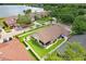 Overhead view of a home with a fenced-in backyard, situated near a lake and surrounded by verdant trees at 7101 Bucks Ford Dr, Riverview, FL 33578