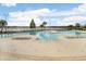 Resort-style community pool with lounge chairs and lake view at 7101 Bucks Ford Dr, Riverview, FL 33578