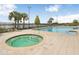 Community pool with a hot tub and view of the lake at 7101 Bucks Ford Dr, Riverview, FL 33578