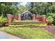 Entrance sign for Lake St. Charles, featuring brick pillars, lush landscaping, and a decorative community marker at 7101 Bucks Ford Dr, Riverview, FL 33578