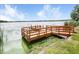 Wooden dock by the lake, with trees at 7101 Bucks Ford Dr, Riverview, FL 33578