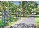 Scenic workout path with exercise equipment in a landscaped community park setting with mature shade trees at 7101 Bucks Ford Dr, Riverview, FL 33578