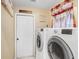 Well-lit laundry room with washer, dryer, and door to the outside at 7101 Bucks Ford Dr, Riverview, FL 33578