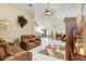 Bright living room featuring tile floors, ceiling fan, comfortable seating, and a decorative fireplace at 7101 Bucks Ford Dr, Riverview, FL 33578
