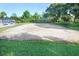 Sandy volleyball court surrounded by trees and benches at 7101 Bucks Ford Dr, Riverview, FL 33578