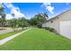 Lush green lawn with manicured landscaping that enhances the home's curb appeal and creates an inviting outdoor space at 7101 Bucks Ford Dr, Riverview, FL 33578