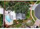 Aerial view of property featuring a pool, patio area, mature trees, and defined property lines at 7111 Lawnview Ct, Tampa, FL 33615