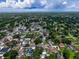 Wide aerial view shows a residential community with established trees, lawns, and homes under a cloudy sky at 7111 Lawnview Ct, Tampa, FL 33615