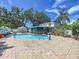 Spacious backyard featuring a pool, patio dining set, and screened lanai at 7111 Lawnview Ct, Tampa, FL 33615