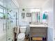 Updated bathroom with a walk in shower, modern vanity, and a decorative mirror at 7111 Lawnview Ct, Tampa, FL 33615