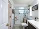 Bathroom with tiled shower and glass door, neutral tones, and modern fixtures at 7111 Lawnview Ct, Tampa, FL 33615