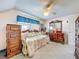 Pleasant bedroom with a daybed, ceiling fan, and wooden dressers for storage and comfort at 7111 Lawnview Ct, Tampa, FL 33615