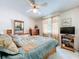 Charming bedroom with a ceiling fan, TV, and warm-toned decor for a relaxing atmosphere at 7111 Lawnview Ct, Tampa, FL 33615