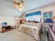 Cozy bedroom featuring a daybed, ceiling fan, and window for natural light and comfort at 7111 Lawnview Ct, Tampa, FL 33615