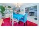 Inviting dining room with a blue table cloth, decorative chandelier, and large display cabinet at 7111 Lawnview Ct, Tampa, FL 33615