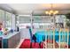Bright dining area with an aqua tablecloth, a modern chandelier, and a view of the pool area at 7111 Lawnview Ct, Tampa, FL 33615