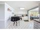 Kitchen featuring a built in desk area, black table and chairs, and white cabinetry at 7111 Lawnview Ct, Tampa, FL 33615