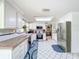 Bright kitchen featuring white cabinets, stainless steel appliances, and tiled floors at 7111 Lawnview Ct, Tampa, FL 33615