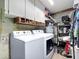 Functional laundry room with a washer, dryer, and storage cabinets for organization at 7111 Lawnview Ct, Tampa, FL 33615