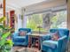 Charming living room featuring comfortable seating, natural light, and scenic outdoor views at 7111 Lawnview Ct, Tampa, FL 33615