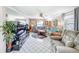 Spacious living room featuring a plush sectional sofa, tile floors, and large windows at 7111 Lawnview Ct, Tampa, FL 33615