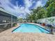 Refreshing pool area with a screened-in lanai and tiled patio at 7111 Lawnview Ct, Tampa, FL 33615
