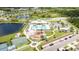 Community aerial view showcasing a pool, playground, and recreation facilities by a lake at 7211 Ozello Trail Ave, Sun City Center, FL 33573