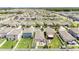 Aerial view of a neighborhood with a well-maintained lawns and neatly arranged houses at 7211 Ozello Trail Ave, Sun City Center, FL 33573