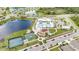 Community aerial view showcasing a pool, playground, and recreation facilities by a lake at 7211 Ozello Trail Ave, Sun City Center, FL 33573
