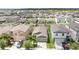 Aerial view of a home with a well-maintained lawn and a two-car garage at 7211 Ozello Trail Ave, Sun City Center, FL 33573
