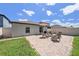 Private backyard featuring a brick patio, comfortable wooden chairs, and green grass at 7211 Ozello Trail Ave, Sun City Center, FL 33573