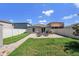 Private backyard featuring a brick patio, comfortable wooden chairs, and green grass at 7211 Ozello Trail Ave, Sun City Center, FL 33573