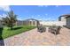 Private backyard featuring a brick patio, a shed, and comfortable wooden chairs at 7211 Ozello Trail Ave, Sun City Center, FL 33573