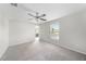 Bright bedroom features a ceiling fan, neutral walls, carpet flooring and an ensuite bathroom at 7211 Ozello Trail Ave, Sun City Center, FL 33573