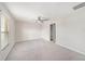 Bright bedroom features a ceiling fan, neutral walls, carpet flooring and an ensuite bathroom at 7211 Ozello Trail Ave, Sun City Center, FL 33573