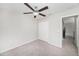 Bedroom with ceiling fan, closet, neutral walls, carpet flooring and an ensuite bathroom at 7211 Ozello Trail Ave, Sun City Center, FL 33573