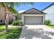 Charming single-story home featuring a well-maintained lawn and a spacious two-car garage at 7211 Ozello Trail Ave, Sun City Center, FL 33573