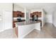 Spacious kitchen island with granite countertops, dark cabinetry, and black appliances at 7211 Ozello Trail Ave, Sun City Center, FL 33573