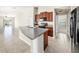 Kitchen featuring granite countertops, dark wood cabinets, and modern black appliances overlooking living room at 7211 Ozello Trail Ave, Sun City Center, FL 33573