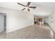 Bright, open-concept living space connects to the kitchen, featuring neutral walls and tile floors at 7211 Ozello Trail Ave, Sun City Center, FL 33573