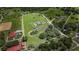Aerial view of estate featuring a home with a pool, pond, and extensive green space, all within property lines at 7301 Loghouse Rd, Plant City, FL 33565