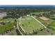 Expansive property featuring a large house, pond, and green fields surrounded by lush trees, providing privacy at 7301 Loghouse Rd, Plant City, FL 33565