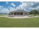 Expansive backyard featuring a brick patio and large grassy area, perfect for outdoor activities and entertaining at 7301 Loghouse Rd, Plant City, FL 33565