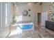 This primary bathroom features a modern tub and lots of natural light at 7301 Loghouse Rd, Plant City, FL 33565