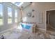 Relax in this luxury tub with a view in the primary bathroom at 7301 Loghouse Rd, Plant City, FL 33565