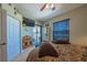 Comfortable bedroom featuring a view of a lake from sliding glass doors at 7301 Loghouse Rd, Plant City, FL 33565