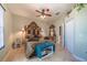 Expansive bedroom features ornate wood headboard, ceiling fan, and neutral color palette at 7301 Loghouse Rd, Plant City, FL 33565