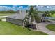 A view of the side of the home highlighting the roof, landscaping, and circular driveway at 7301 Loghouse Rd, Plant City, FL 33565