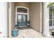 Elegant double front doors with decorative glass and stone tile under a covered entry at 7301 Loghouse Rd, Plant City, FL 33565